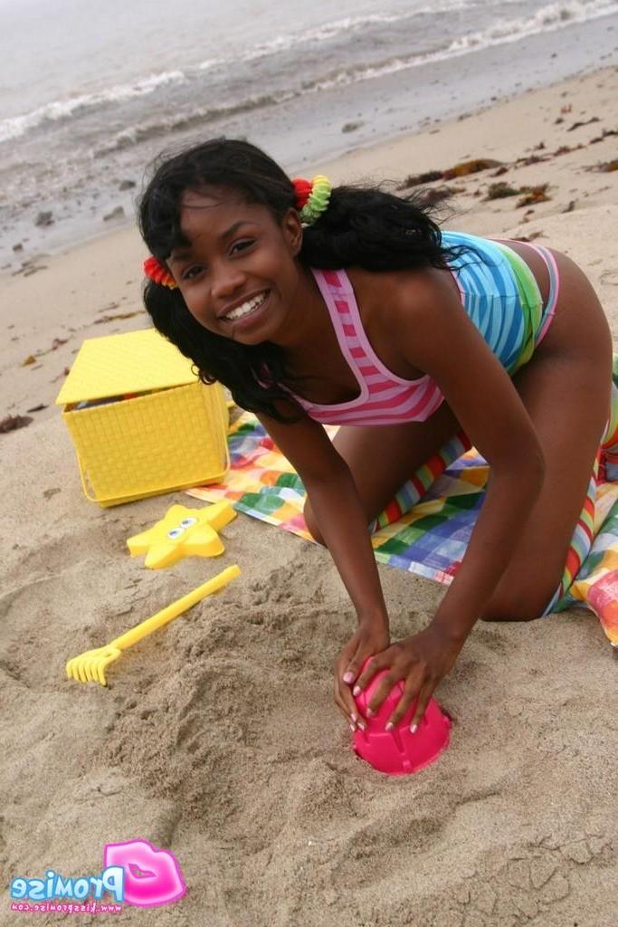 19P Pictures of ebony teen Kiss Promise flashing on a beach