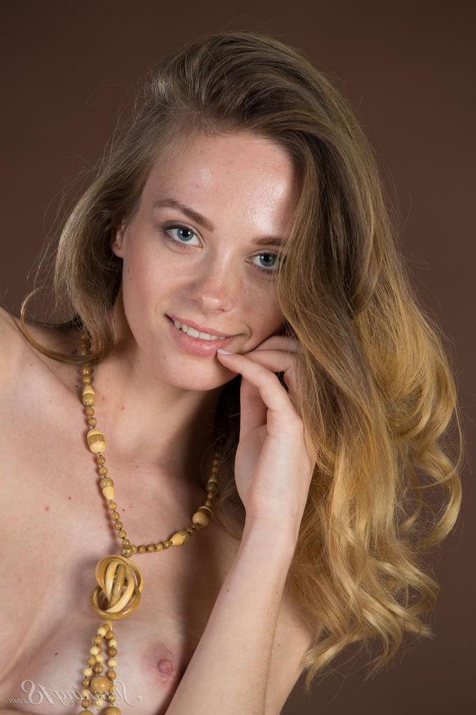 16P Busty teen Irene strips nude for you infront of a brown background