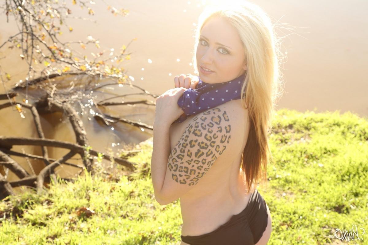 15P Lily Xo poses by the water in her see through shirt