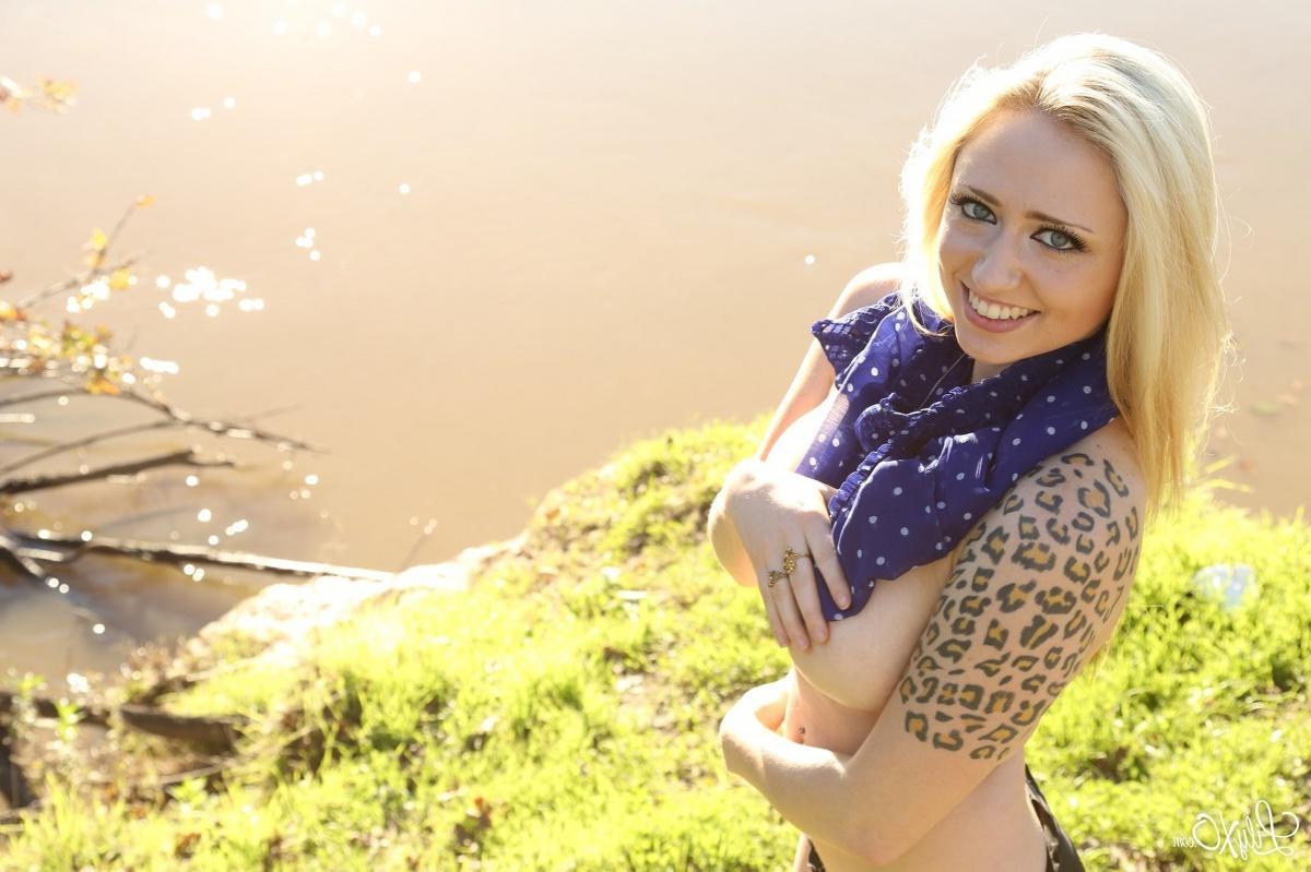 15P Lily Xo poses by the water in her see through shirt