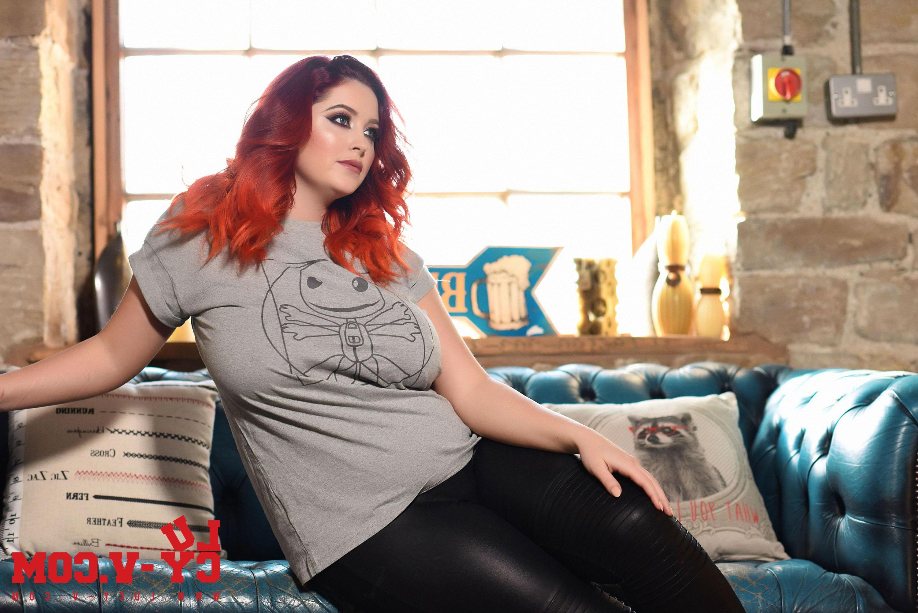 16P Lucy teasing on the sofa in her black pants