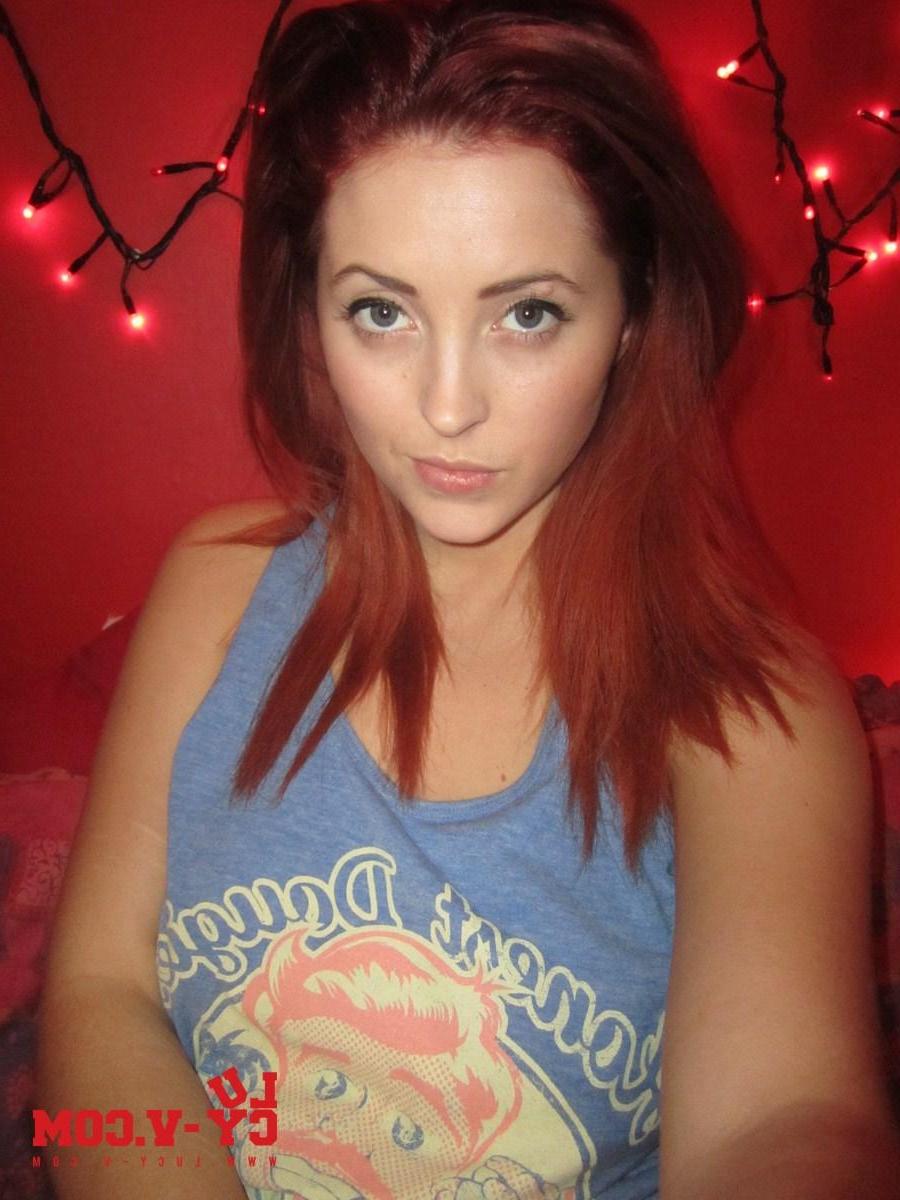 12P Pictures of redhead teen Lucy V looking hot as she takes off her blue top