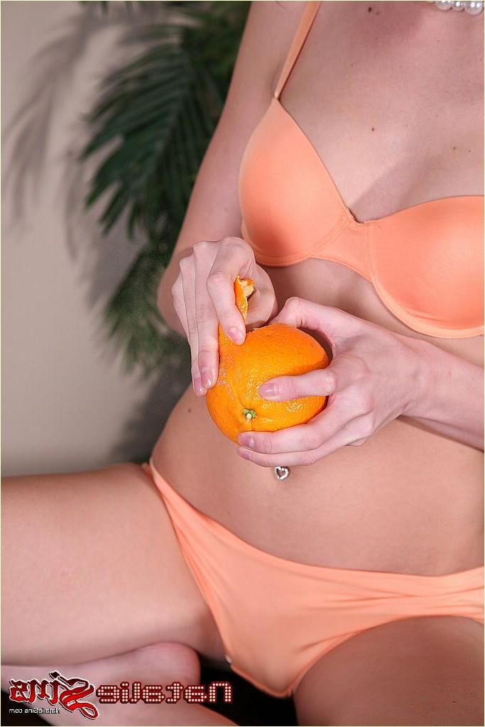 20P Pictures of Natalie Sins getting kinky with an orange