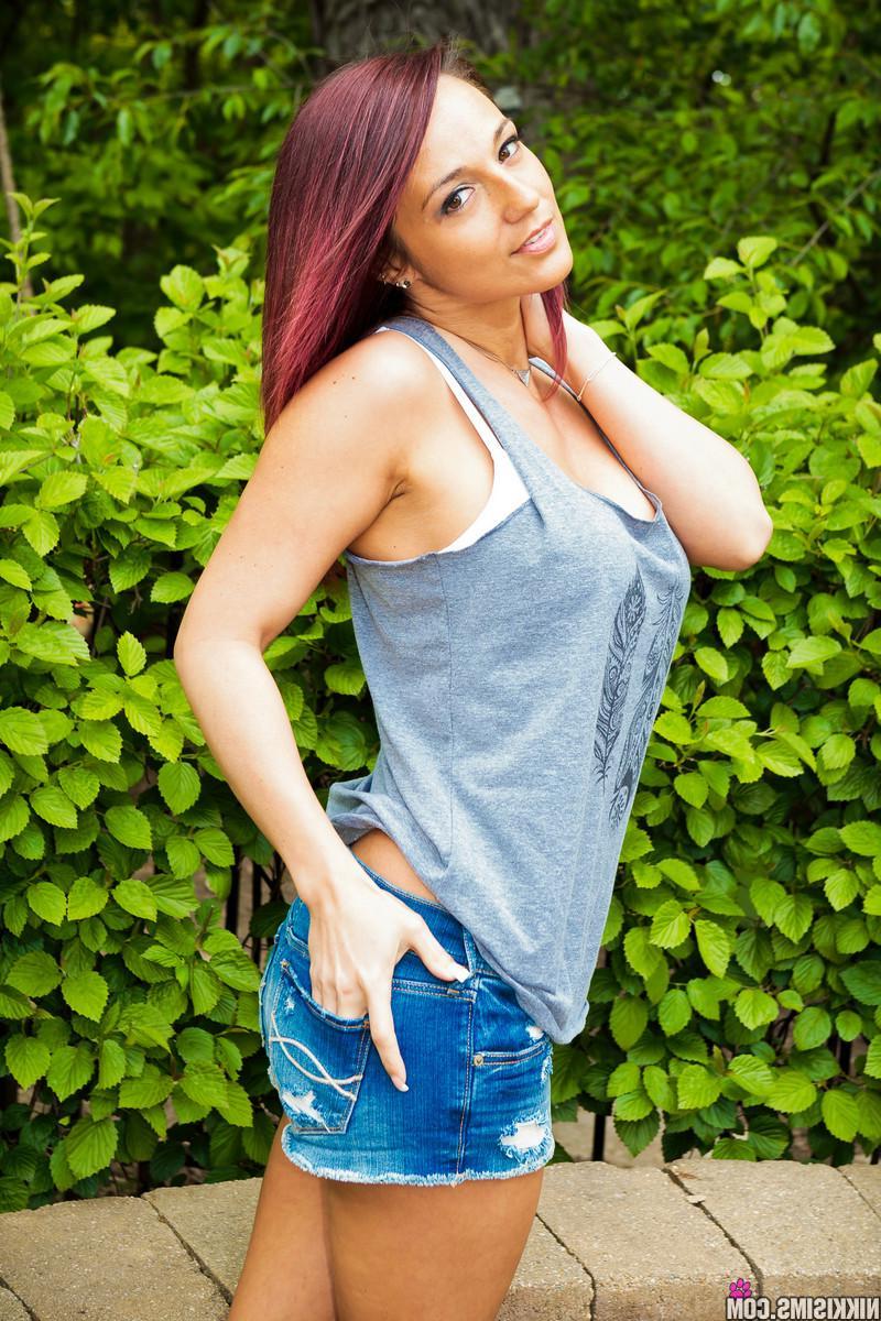 15P Busty beauty Nikki Sims poses and teases in her tank top and shorts
