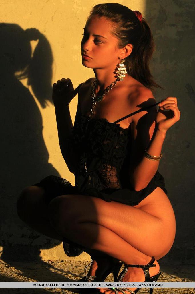 16P Brunette girl Sima B strips out of her black dress just for you