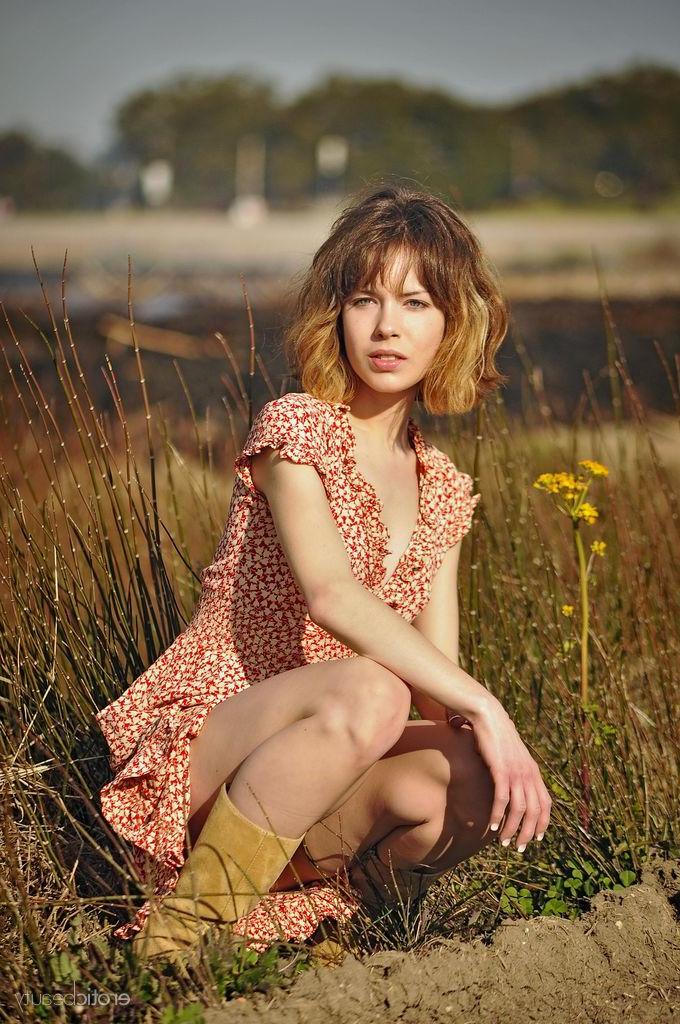 16P Pretty redhead Emily Windsor gets naked outside in "After The Burn"