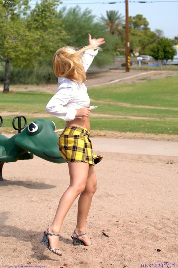20P Pictures of a blonde schoolgirl toying her pussy in a park