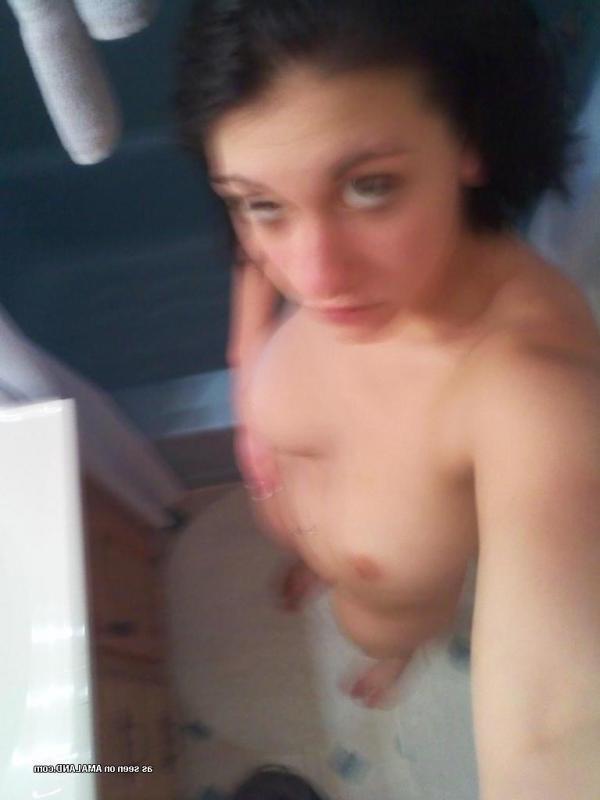 15P Horny brunette babe shows her breasts and pussy