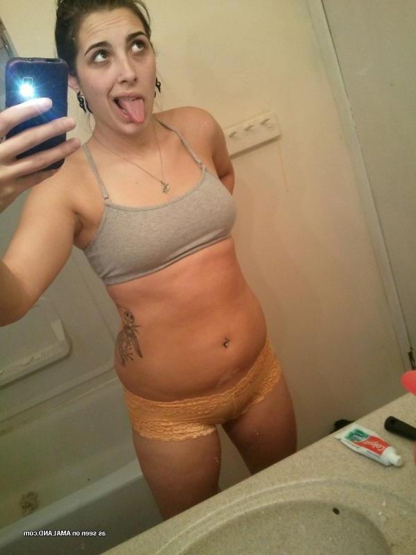15P Horny brunette babe shows her breasts and pussy