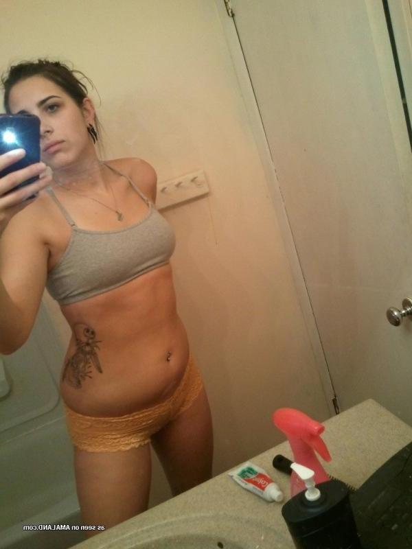 15P Horny brunette babe shows her breasts and pussy