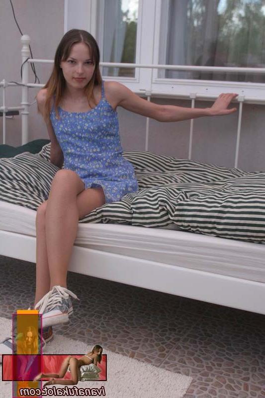 15P Cute teen in pantyhose posing on her bed
