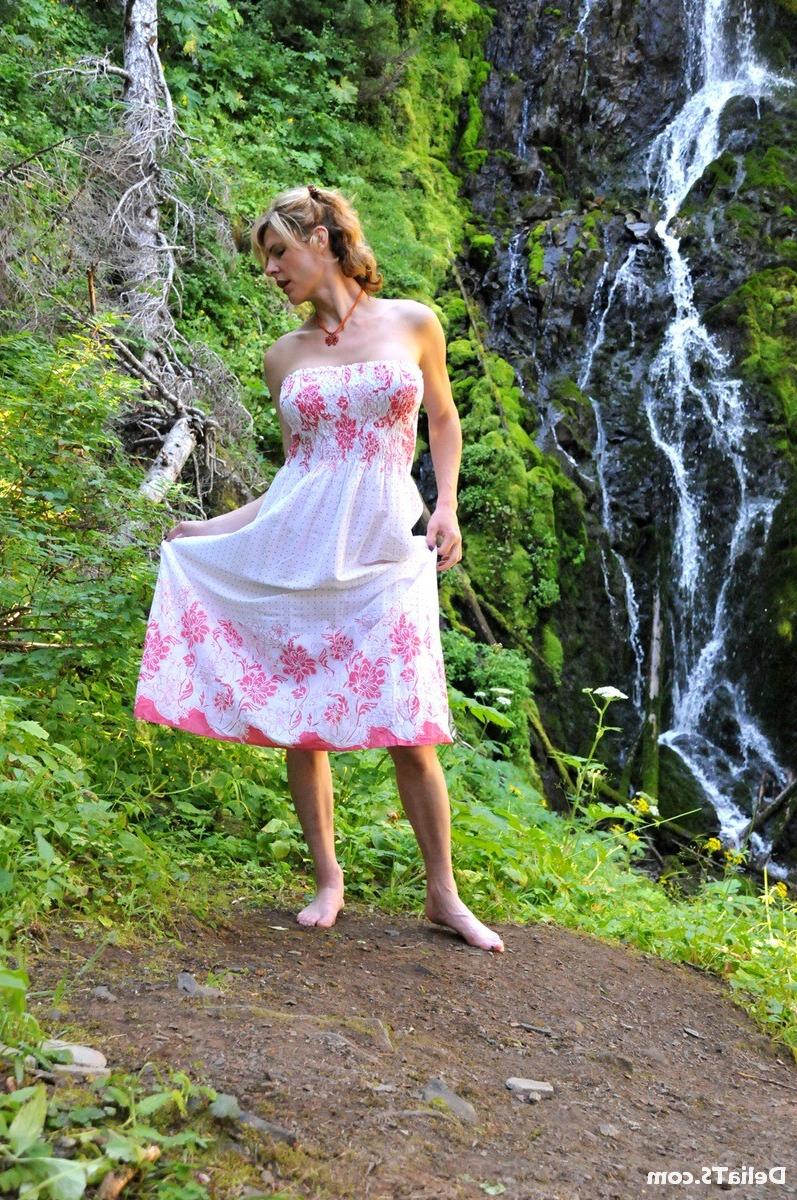 20P Pretty Delia by waterfall erect under her dress