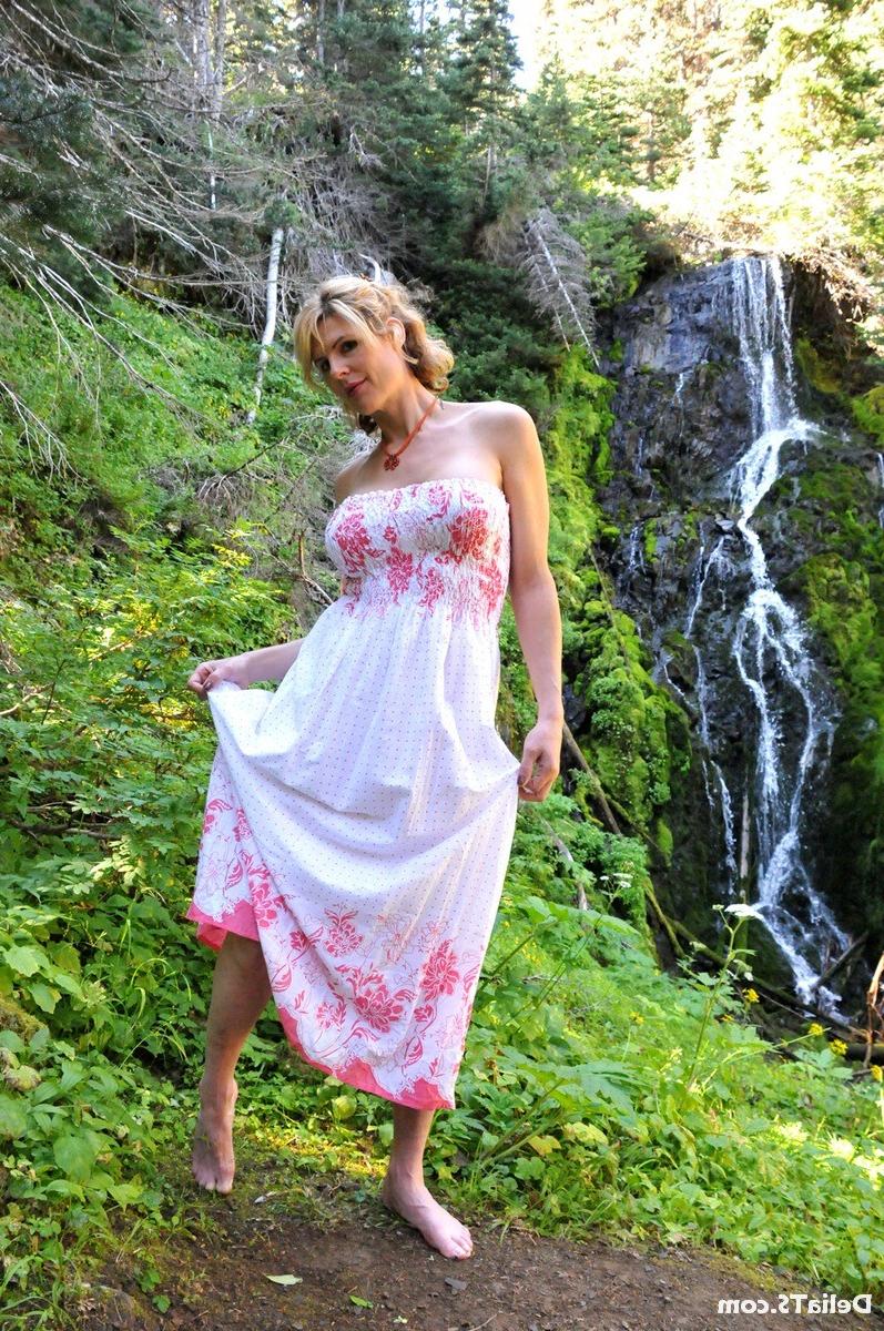 20P Pretty Delia by waterfall erect under her dress