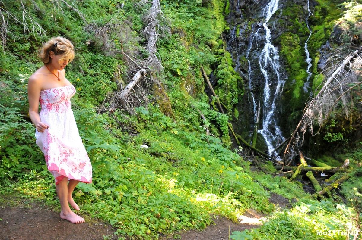 20P Pretty Delia by waterfall erect under her dress