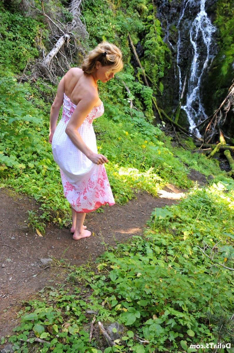 20P Pretty Delia by waterfall erect under her dress