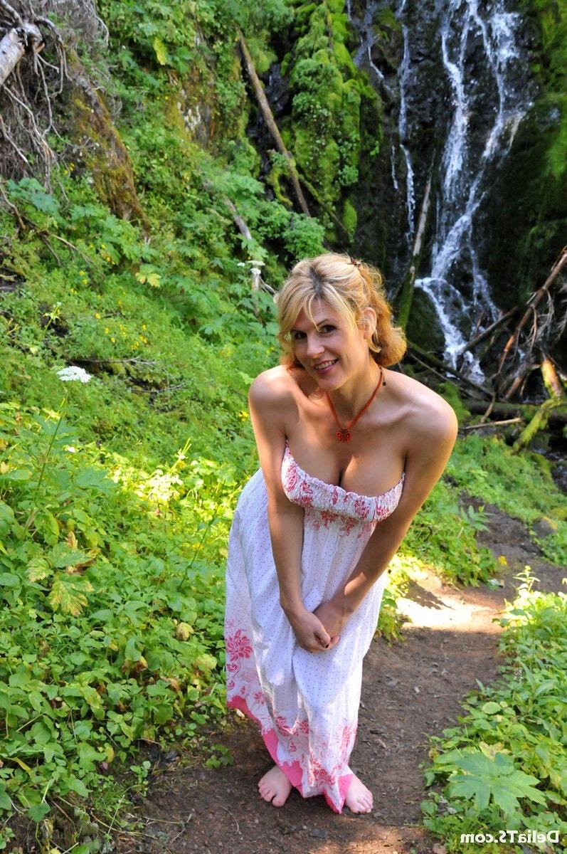 20P Pretty Delia by waterfall erect under her dress
