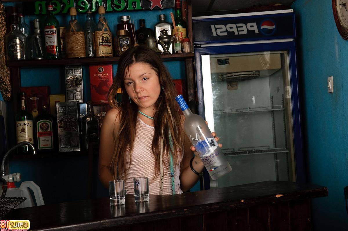 15P Young model Emily 18 pours a shot while in her sheer white lingerie and throws i