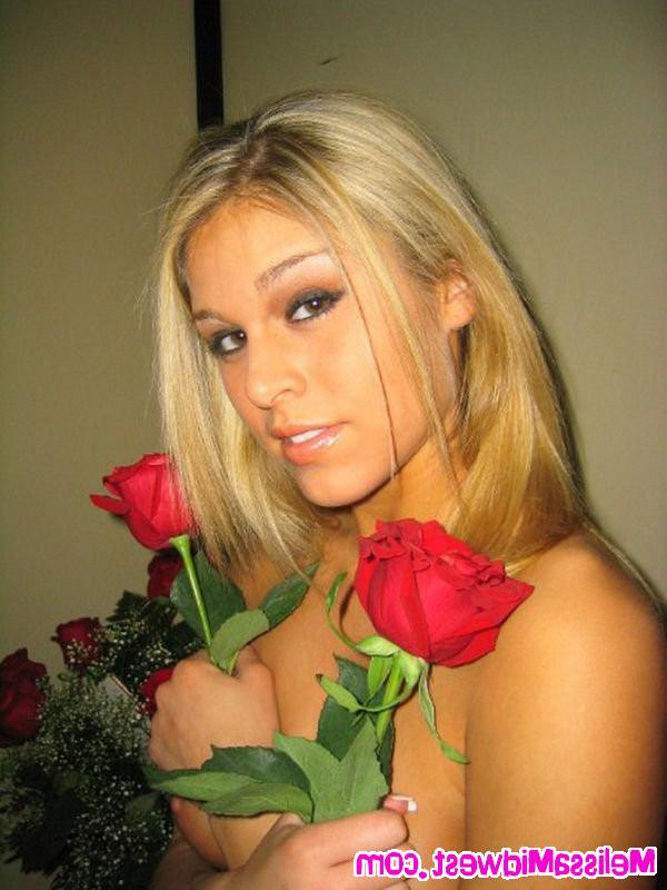16P Melissa Midwest posing with red roses and a teddy bear