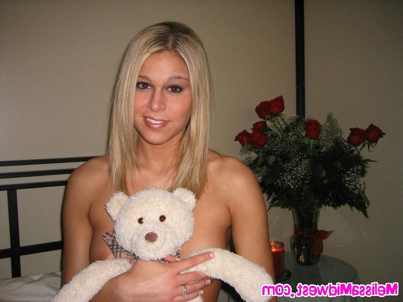16P Melissa Midwest posing with red roses and a teddy bear
