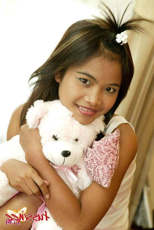 15P Thai Teen Tussinee plays with a teddy bear in bed
