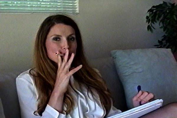 15P A young woman with long hair bares her breasts, utilizes a vibrator, and pensive
