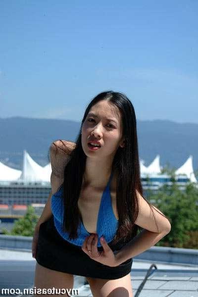 16P She strips out of clothing on top of building
