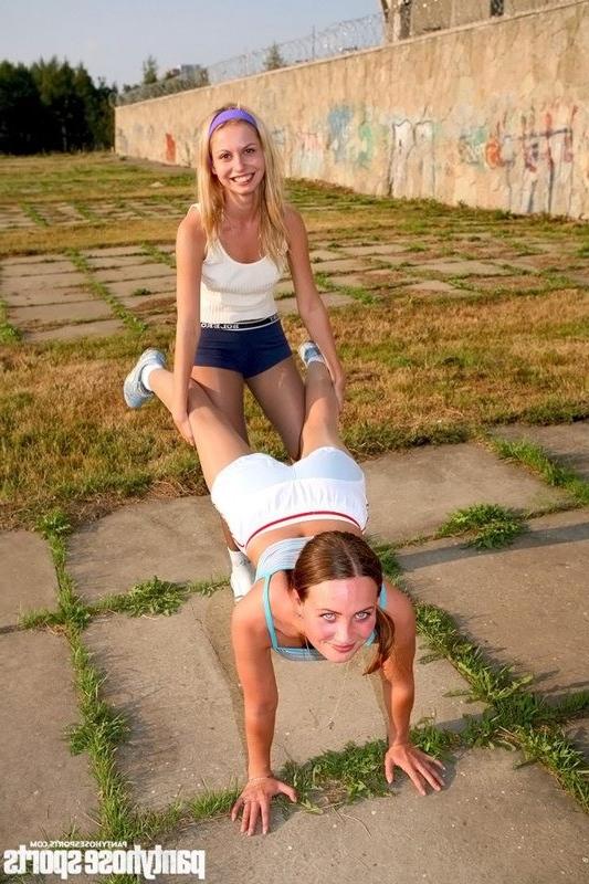15P Two sporty babes exercise in tights outdoors
