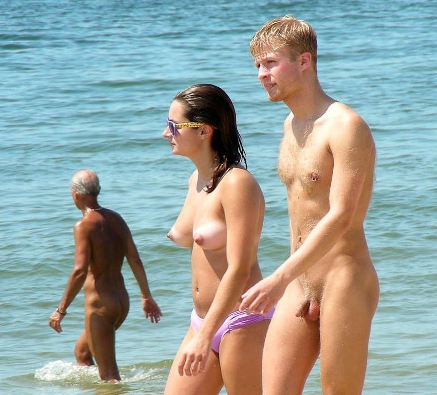 15P Long haired hottie lays around nude at the beach