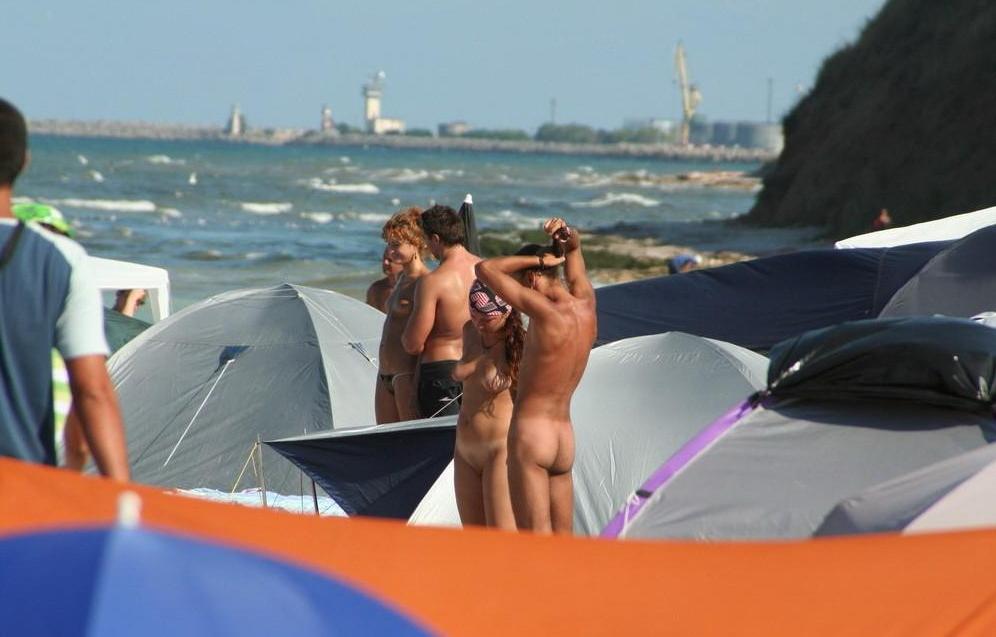 15P At the nudist beach teen girls play around naked