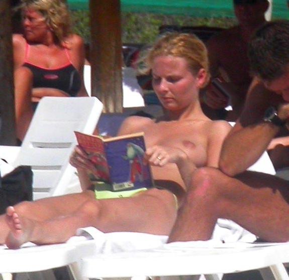 15P Perky breasted sexy babe poses on a nude beach
