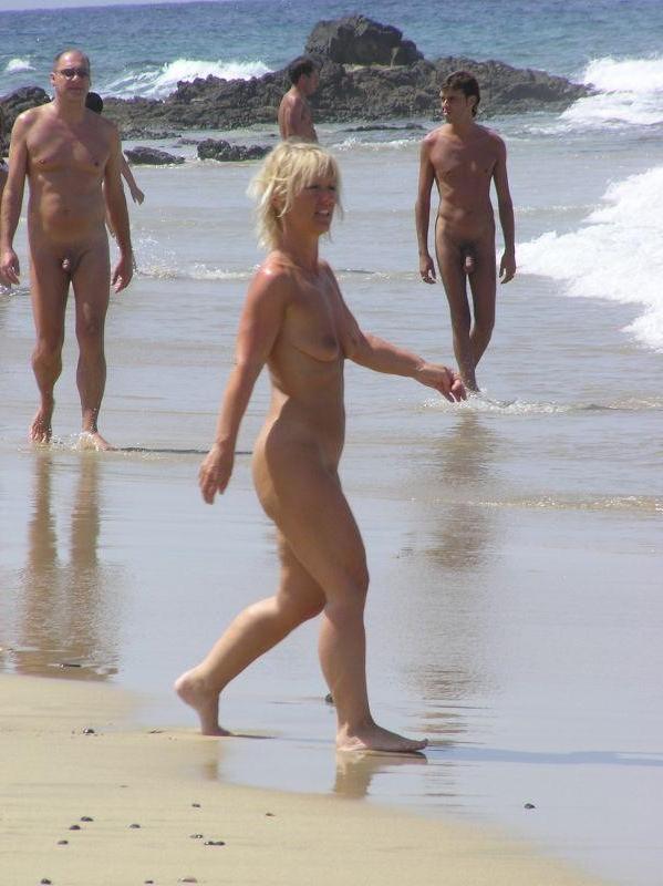 15P Sexy curvaceous cutie strips at a nudist beach