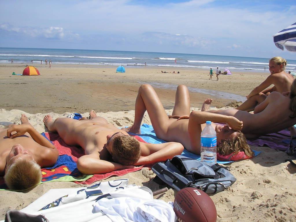 15P A public beach heats up with two hot teen nudists