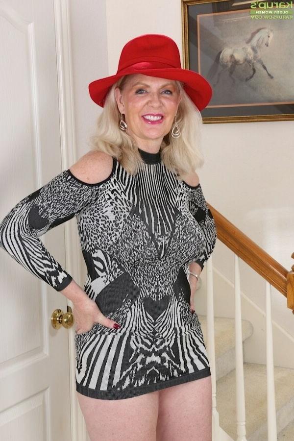 15P Judy Mayflower busty mature blonde poses in red hat