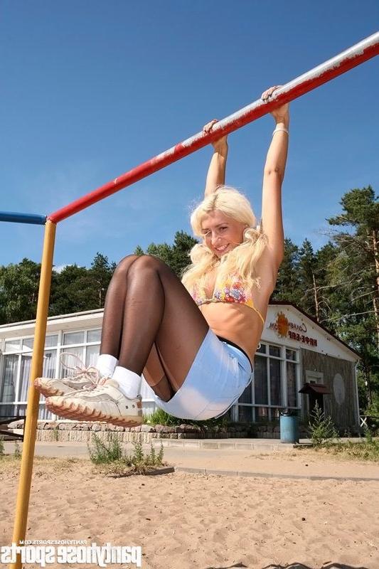 15P Blonde Anastasia in pantyhose doing exercises outdoors