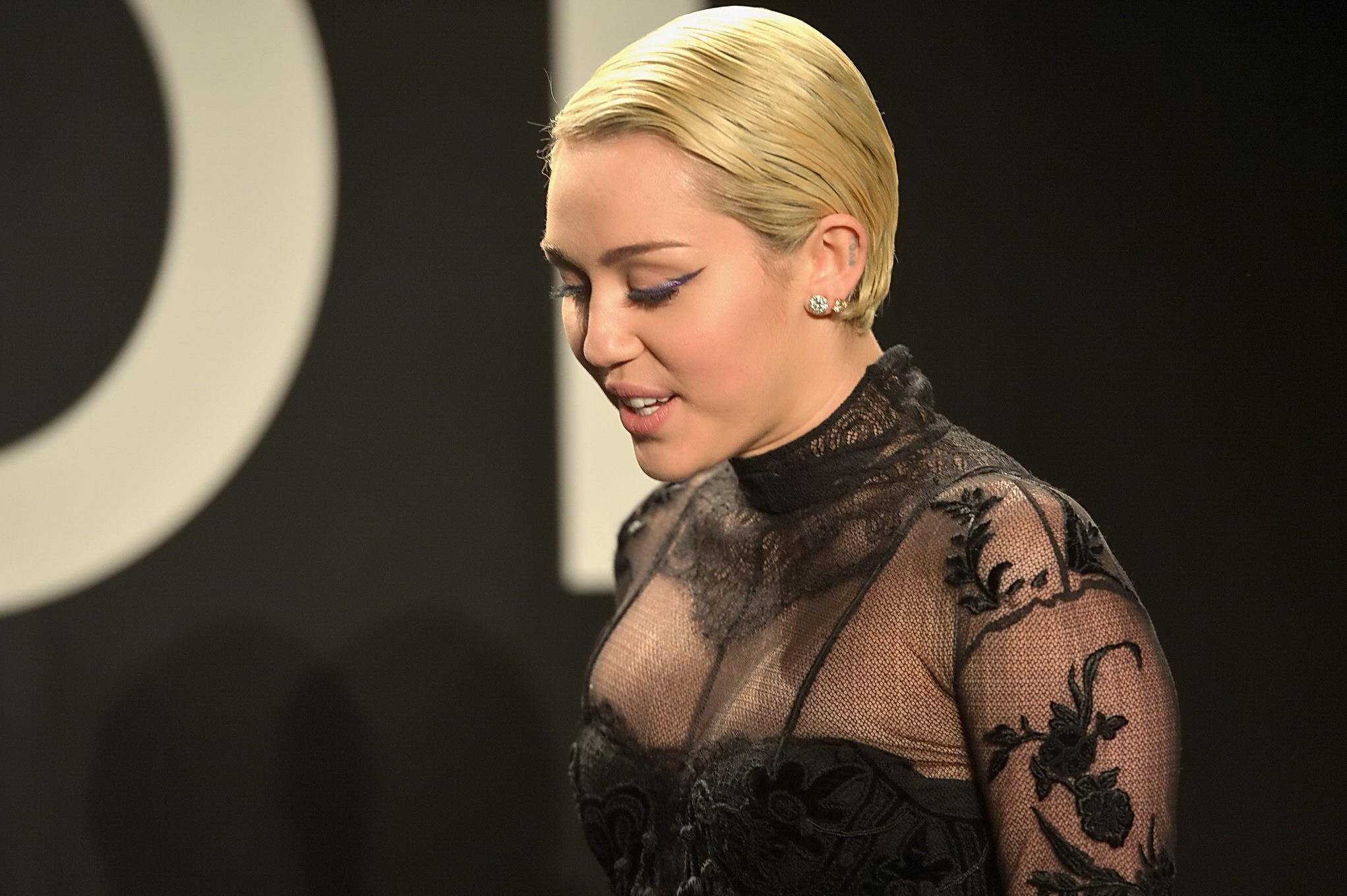 16P Miley Cyrus wearing see through dress and lingerie at Tom Ford 2015 Womenswear C