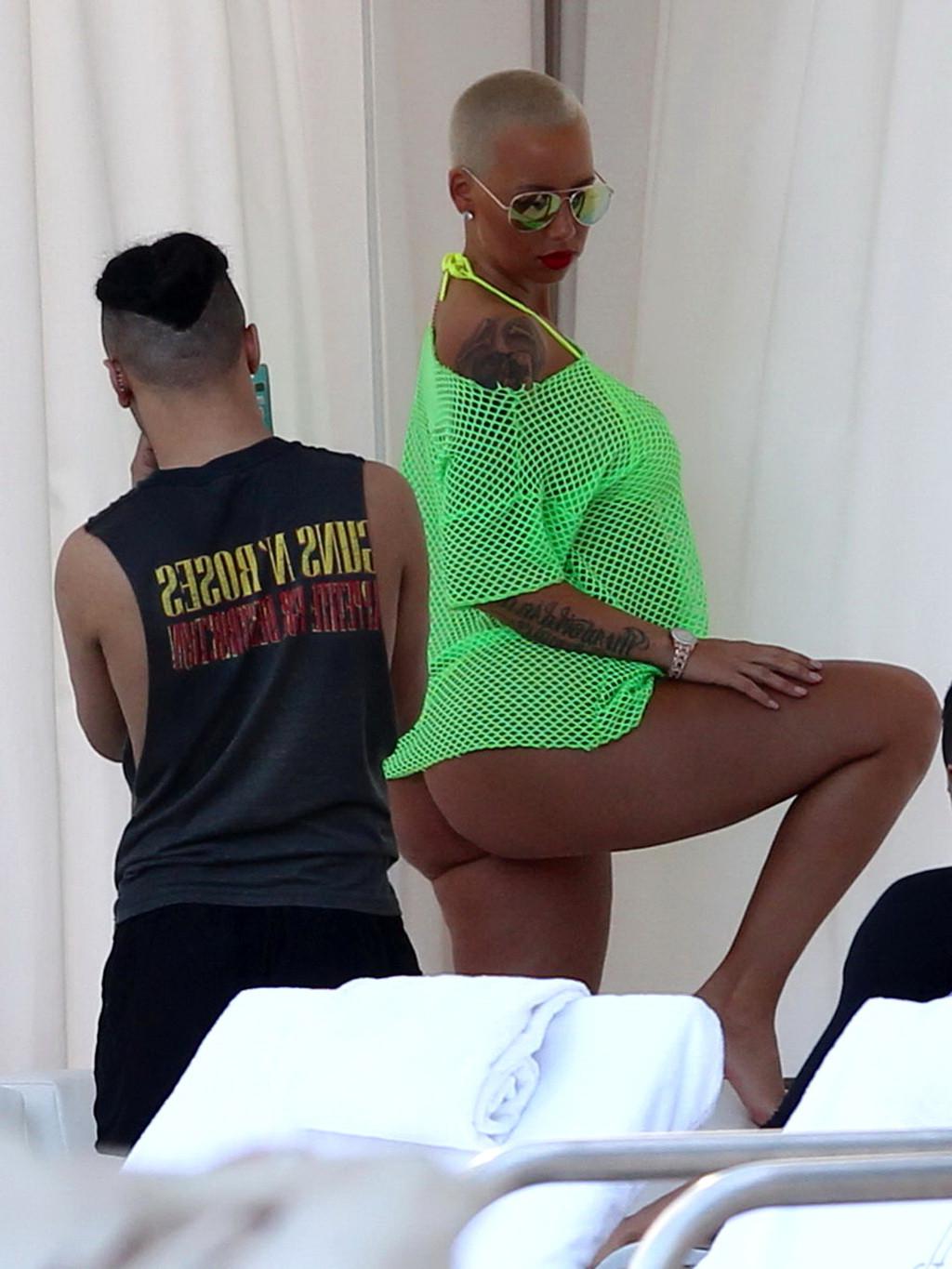 16P Amber Rose shows off her big boobs and ass wearing a see through yellow thong bi