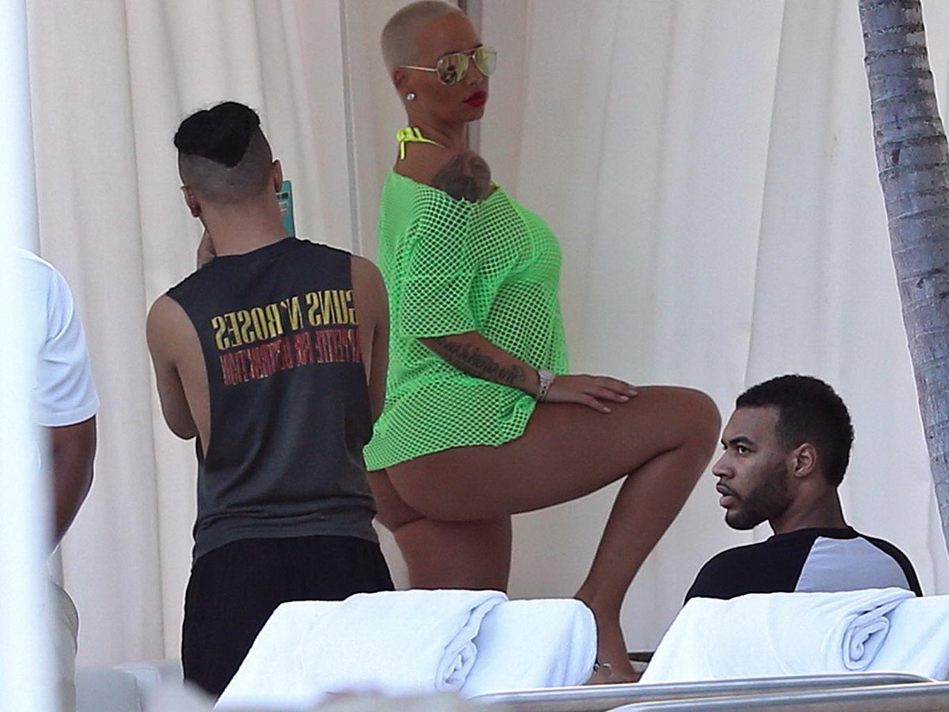 16P Amber Rose shows off her big boobs and ass wearing a see through yellow thong bi
