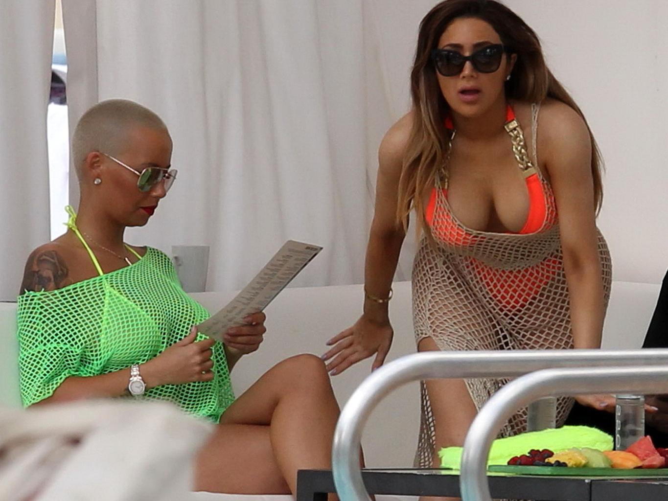 16P Amber Rose shows off her big boobs and ass wearing a see through yellow thong bi