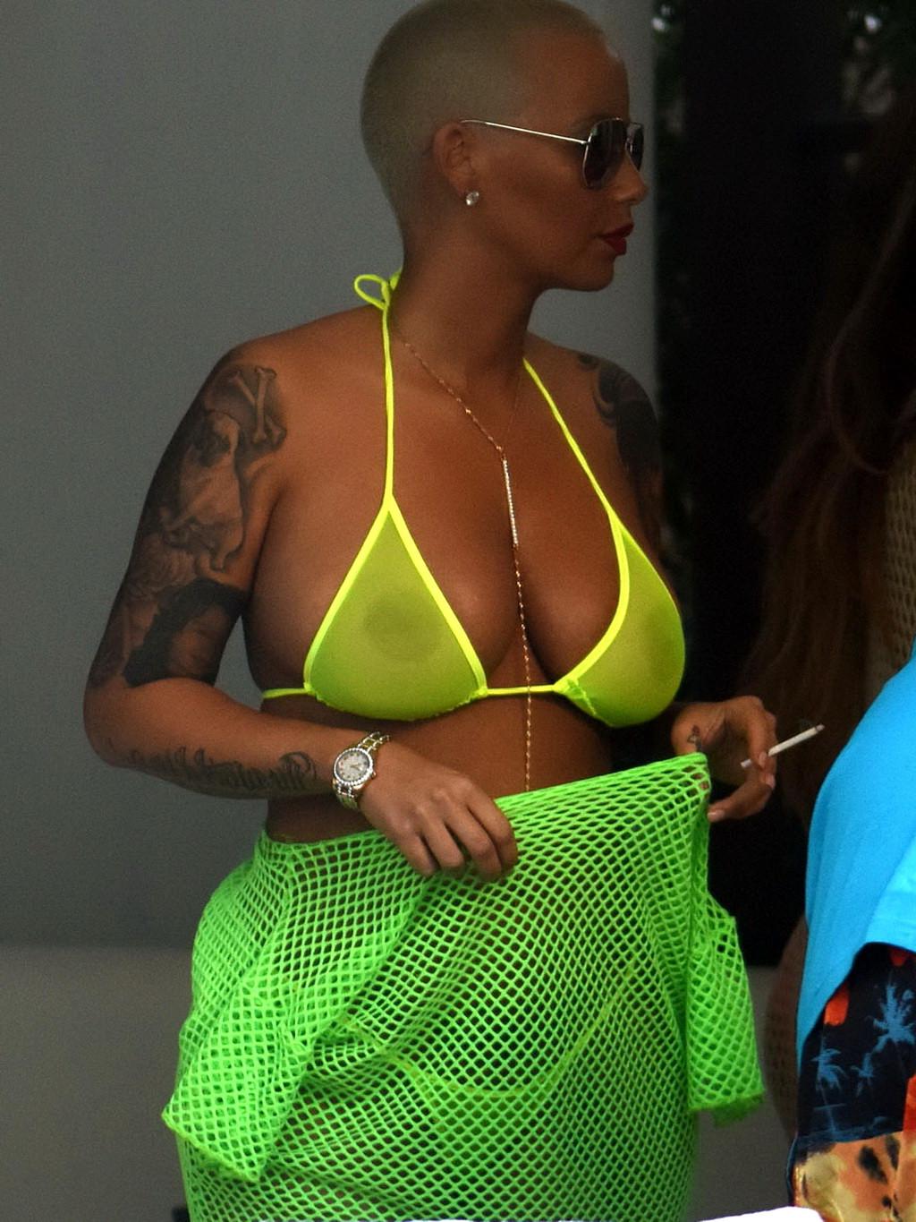 16P Amber Rose shows off her big boobs and ass wearing a see through yellow thong bi