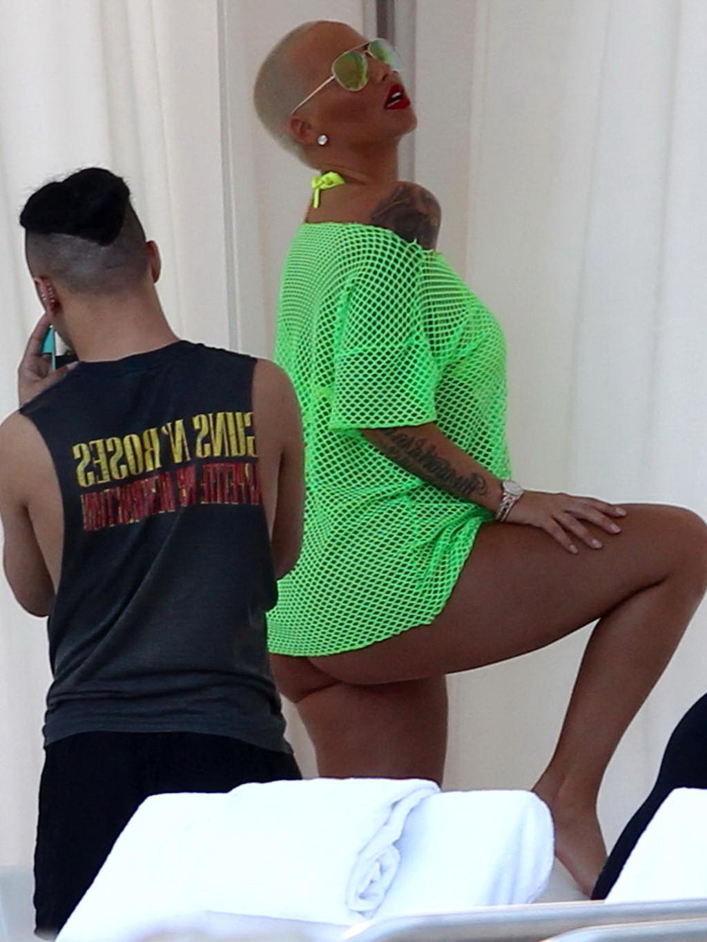 16P Amber Rose shows off her big boobs and ass wearing a see through yellow thong bi