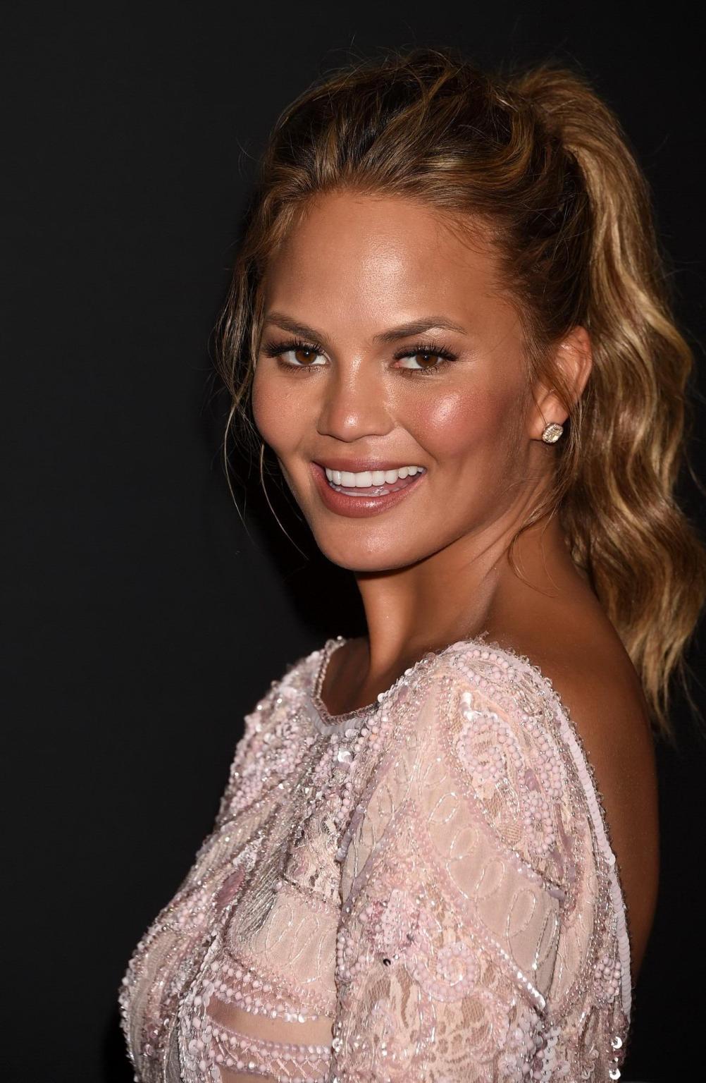 16P Chrissy Teigen shows off her big boobs wearing a see through dress at the InStyl