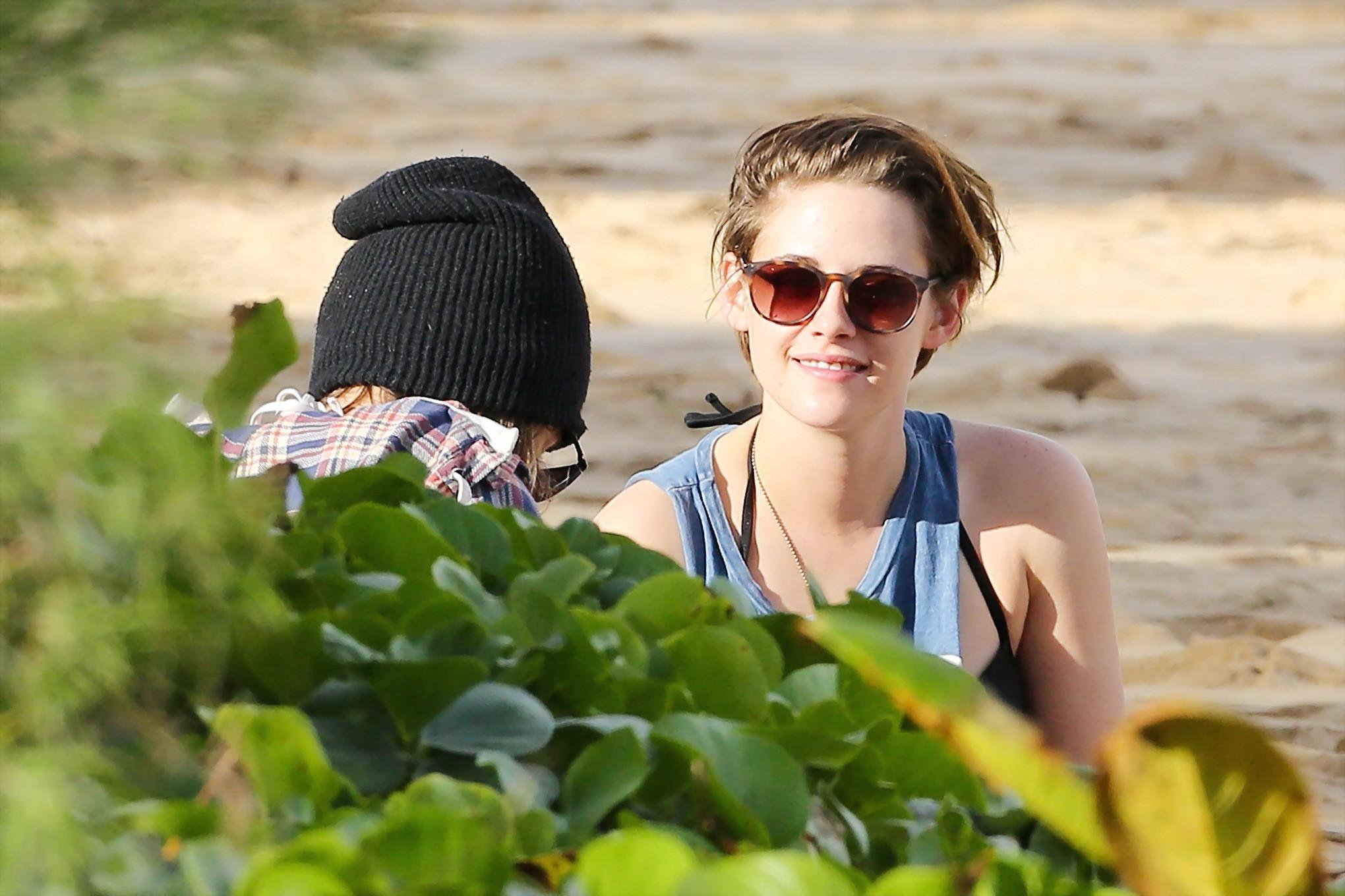 16P Kristen Stewart in bikini top and shorts kissing with some girl on the beach in 