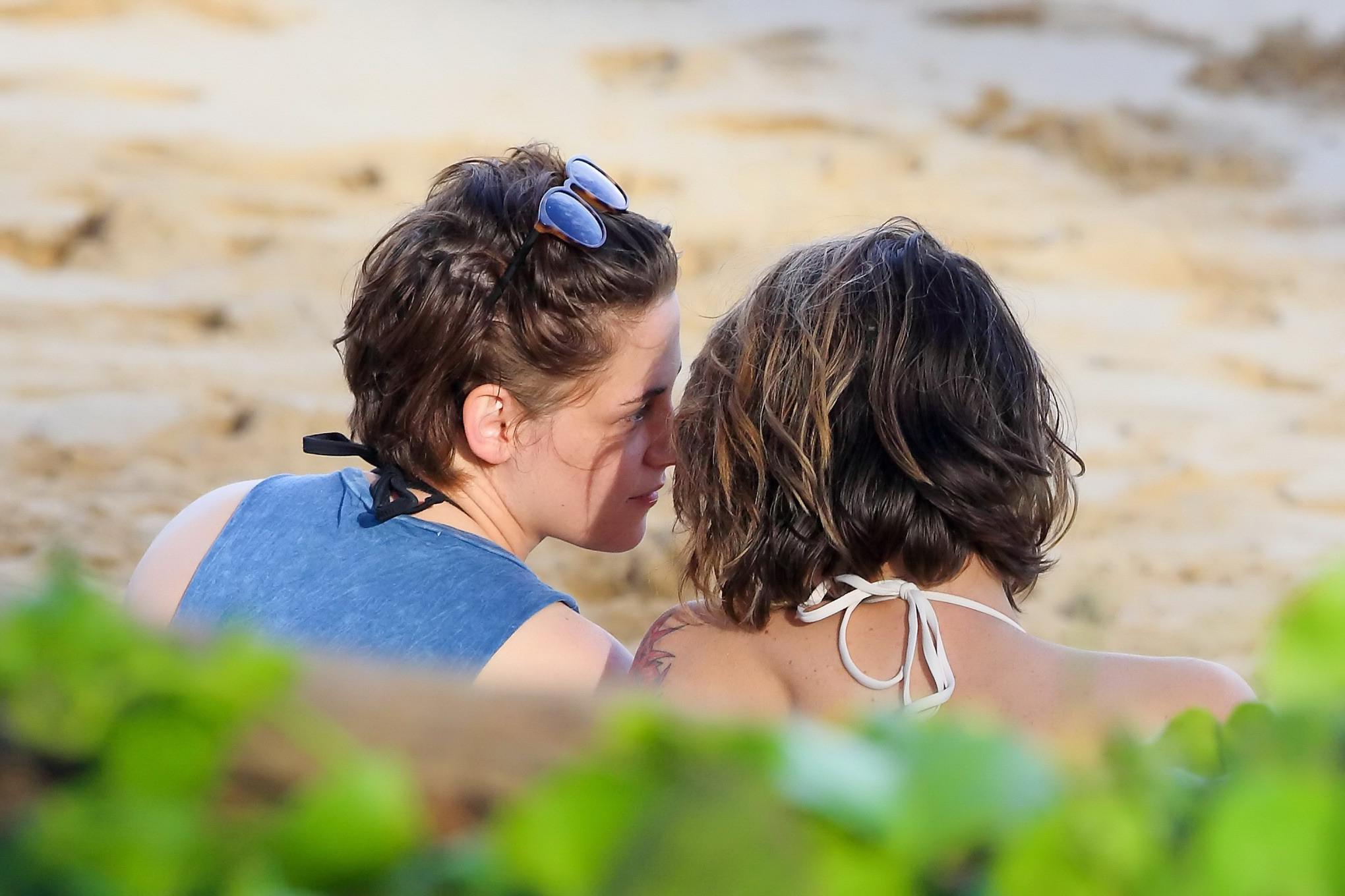 16P Kristen Stewart in bikini top and shorts kissing with some girl on the beach in 