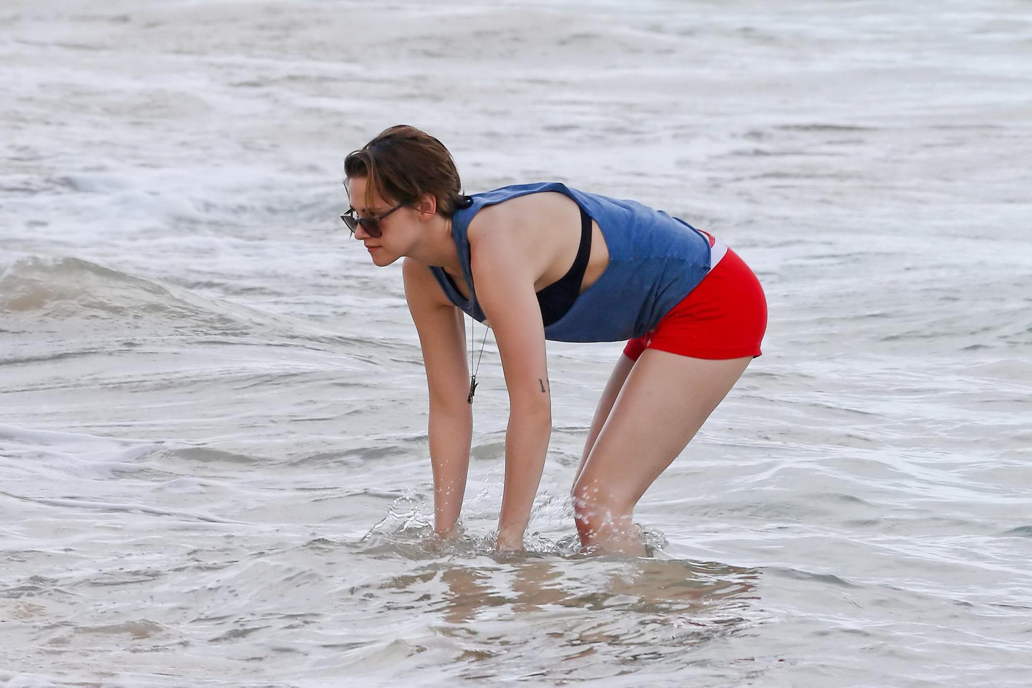 16P Kristen Stewart in bikini top and shorts kissing with some girl on the beach in 