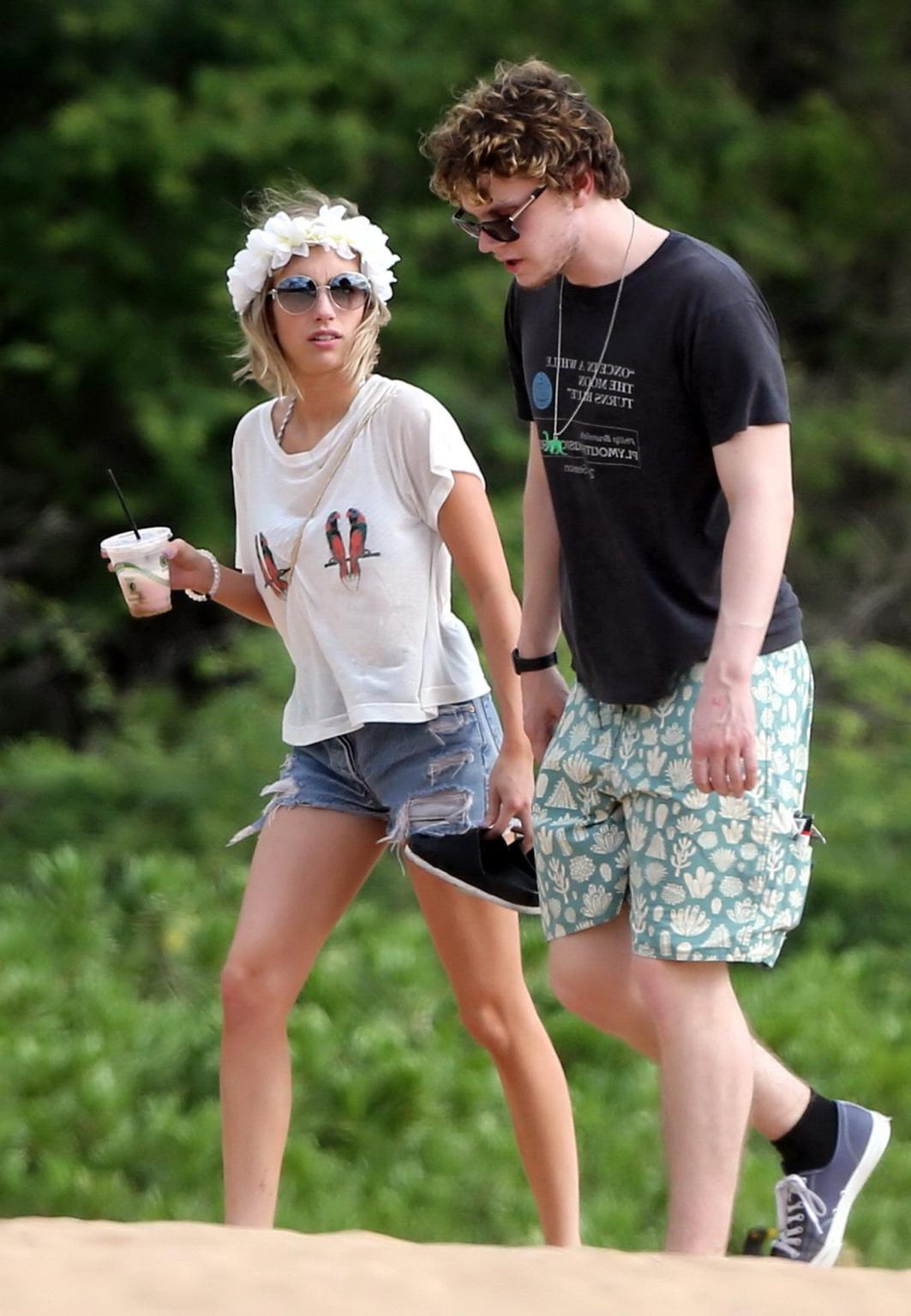 16P Emma Roberts wearing bikini top and shorts on a beach in Maui