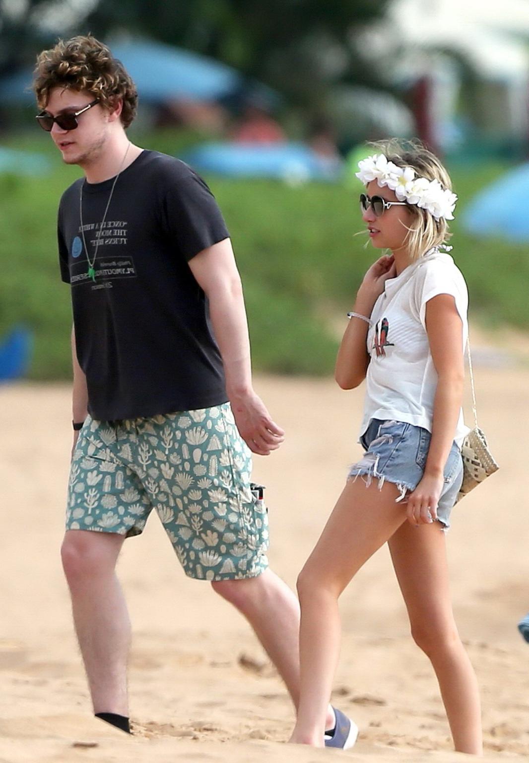 16P Emma Roberts wearing bikini top and shorts on a beach in Maui