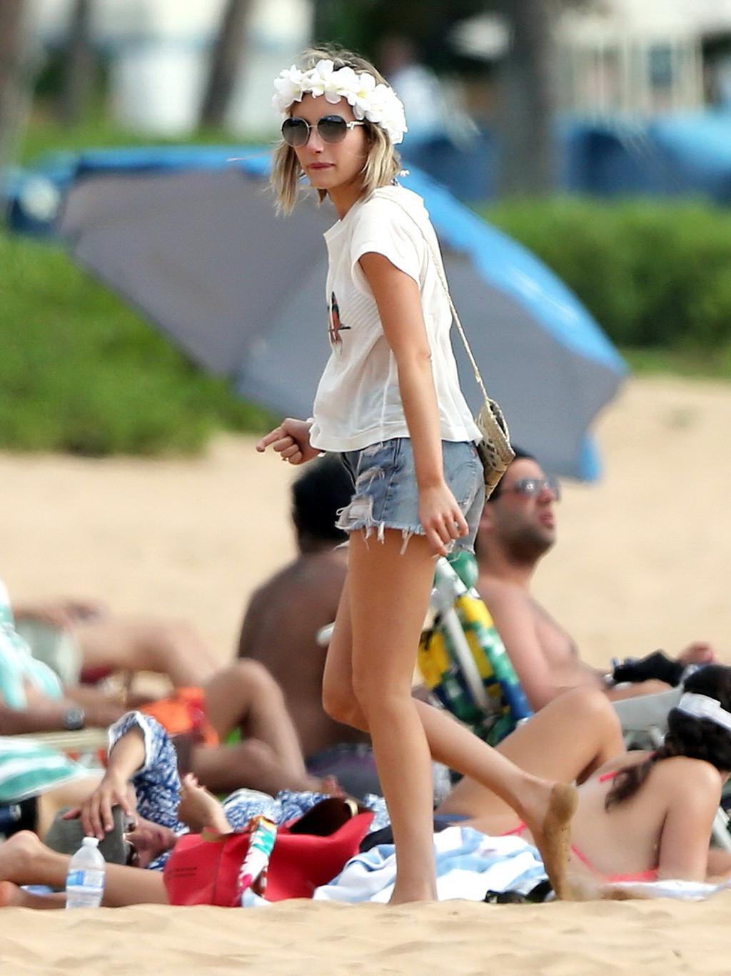 16P Emma Roberts wearing bikini top and shorts on a beach in Maui