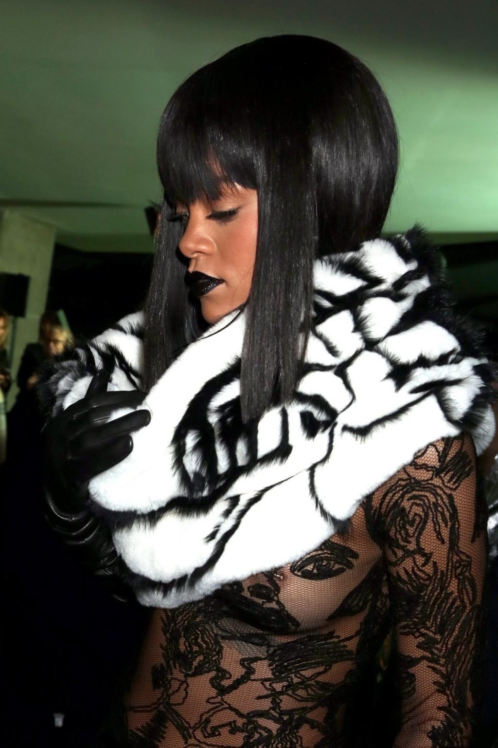 16P Rihanna braless in a black see-through top at Jean Paul Gaultier fashion show in