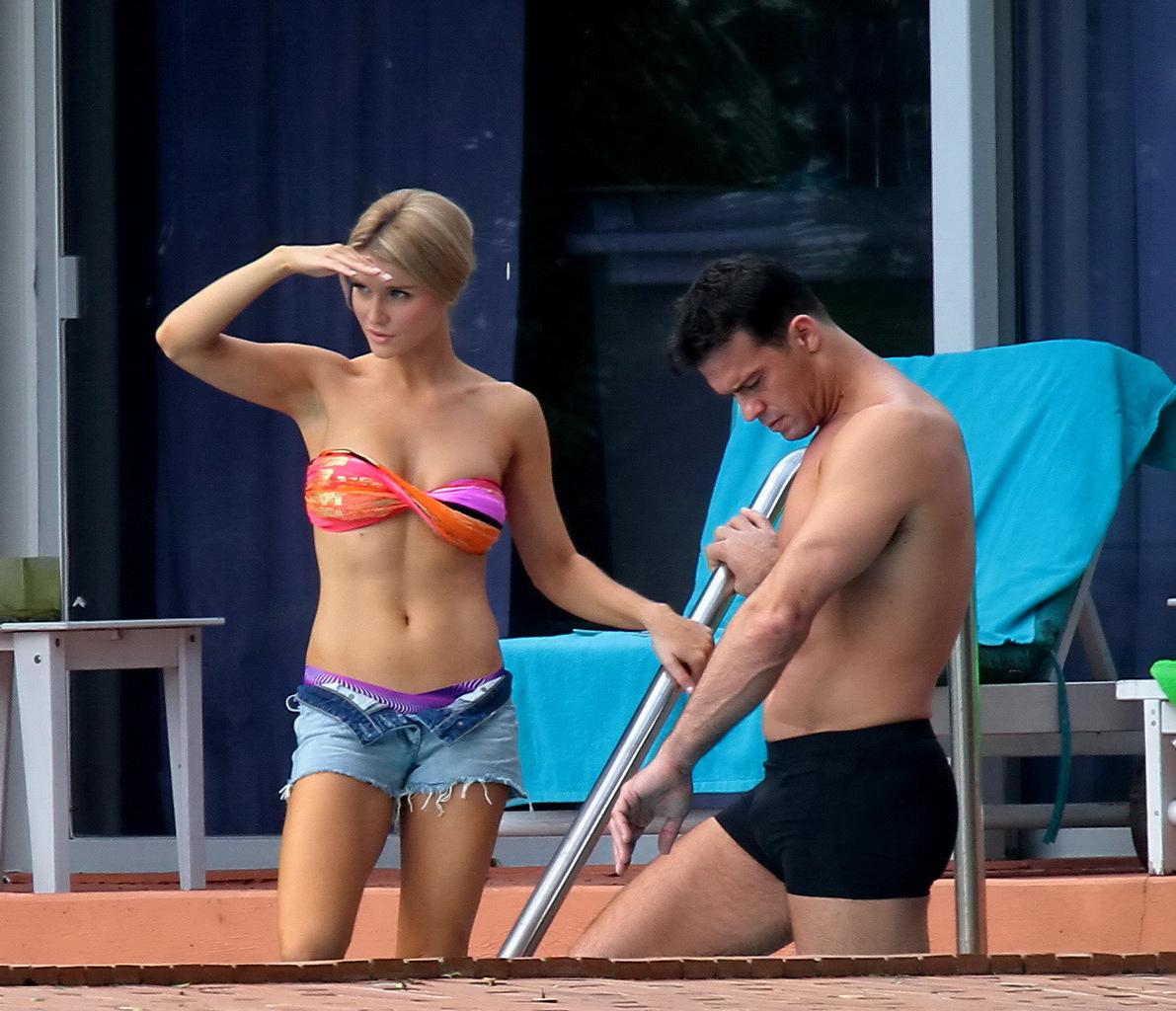 16P Joanna Krupa wearing a strapless bikini top and hotpants poolside in Miami