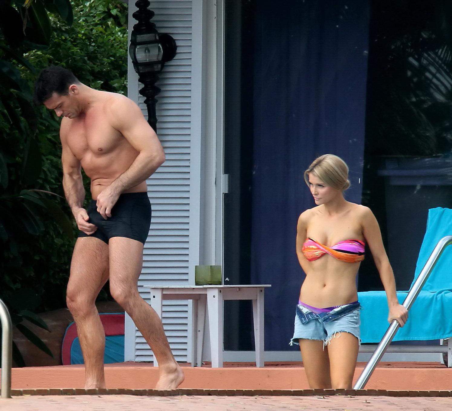 16P Joanna Krupa wearing a strapless bikini top and hotpants poolside in Miami